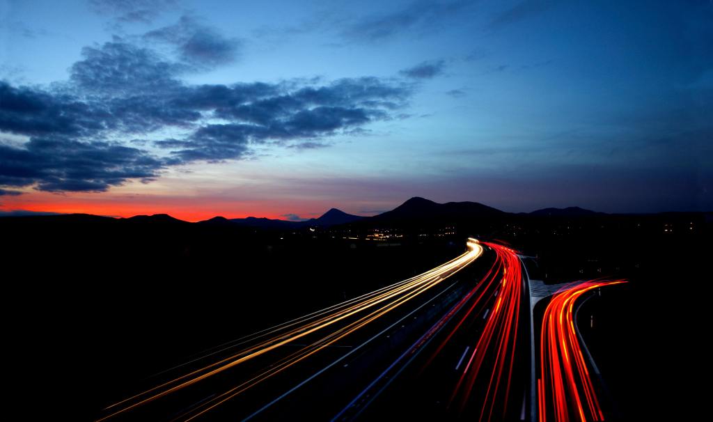 time lapse still of a road going into hills