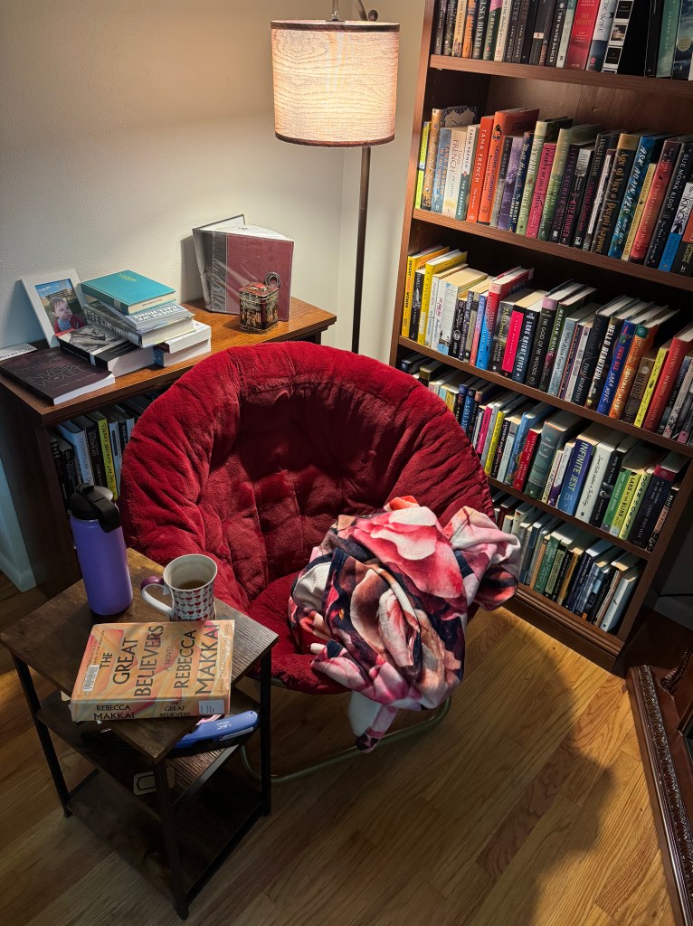 A red saucer chair surrounded by bookshelves